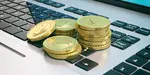 Gold coins and laptop cryptocurrency.