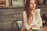 Thoughtful woman in cafe thinking about her life script.