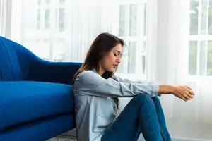 Young woman at home feeling discouraged with regrets.