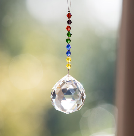 Hanging crystal suncatcher to enhance chakra balancing.