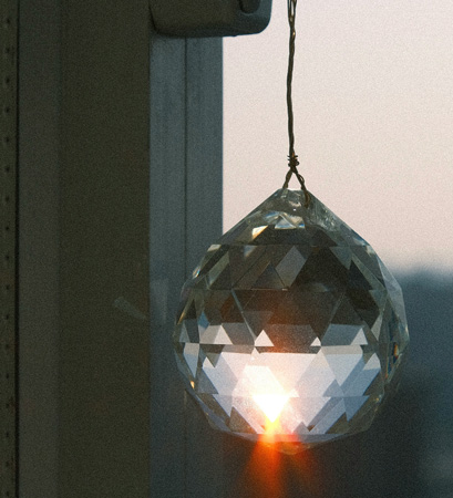 The benefits of a crystal suncatcher include calming and increased positive vibes.