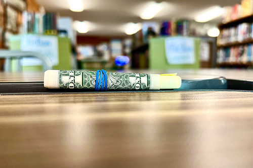 Rolled Up Bill On Table