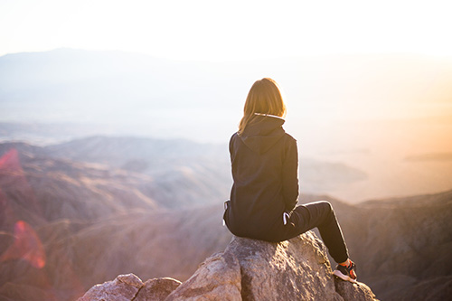 Your New Life - Woman thoughtful viewing mountains and future Your New Life - Woman thoughtful viewing mountains and future