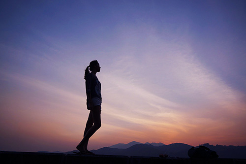 Thoughtful Woman looking at sunrise. Thoughtful Woman looking at sunrise.