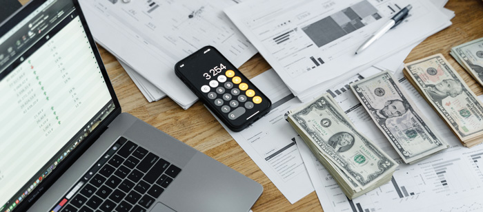 Laptop and piles of bills Laptop and piles of bills