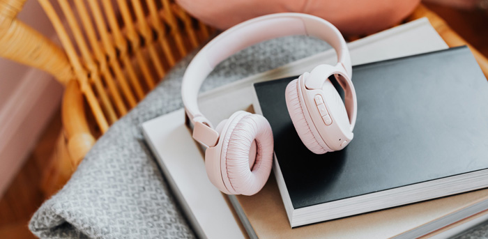 White headphones and notepad for Amazon Audible notes. White headphones and notepad for Amazon Audible notes.