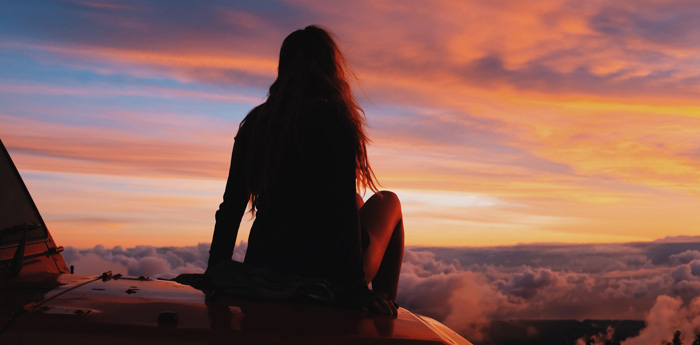 Law of Attraction. Woman thankful at sunset on her jeep. Law of Attraction. Woman thankful at sunset on her jeep.