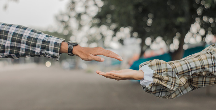 Secrets To Relationships couple reaching hands toward each other. Secrets To Relationships couple reaching hands toward each other.