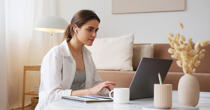 Woman using Billionaire Brain Wave and Audible to manifest wealth.