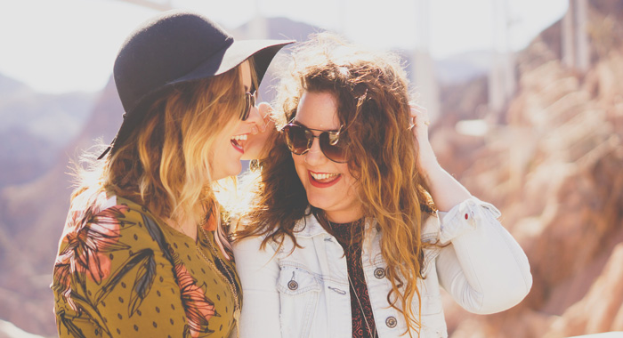 Two older women laughing hats Two older women laughing hats