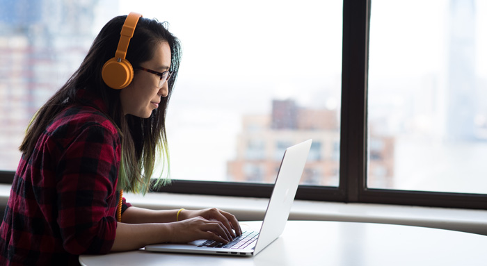 Gen Z young woman listening to binaural beats to assist in manifesting wealth. Gen Z young woman listening to binaural beats to assist in manifesting wealth.