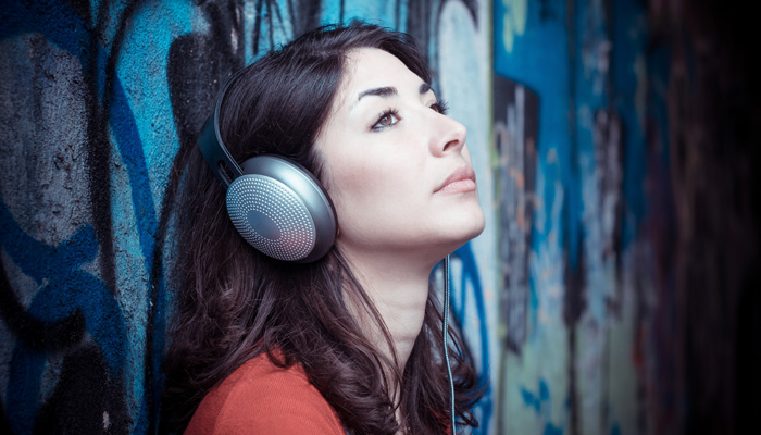 Woman writer listening to Amazon Audible audiobook. Woman writer listening to Amazon Audible audiobook.