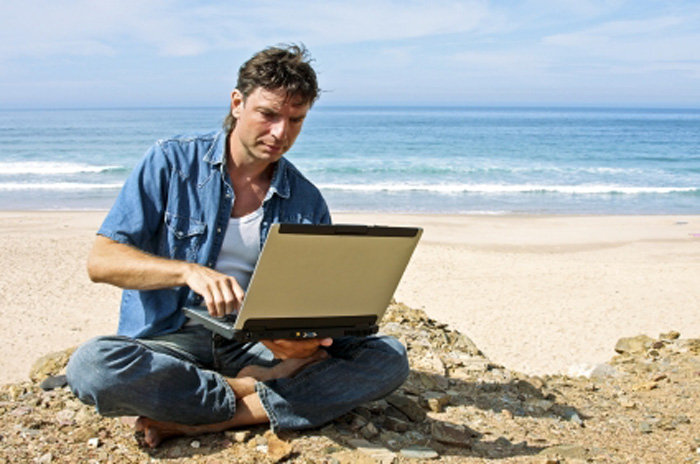 Guy with laptop providing commentary on Amazon Audible books for his YouTube channel. Guy with laptop providing commentary on Amazon Audible books for his YouTube channel.