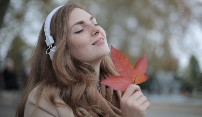 Woman mediate theta waves holding leaf in park. Woman mediate theta waves holding leaf in park.