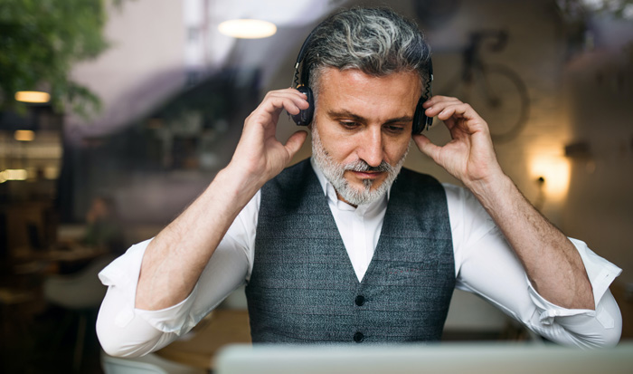 Male writer listening to Amazon Audible. Writers can make big money listening to audiobooks. Male writer listening to Amazon Audible. Writers can make big money listening to audiobooks.