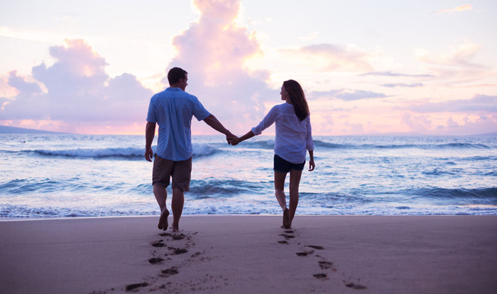 Couple holding hands on the beach. Spirituality and relationships. Couple holding hands on the beach. Spirituality and relationships.