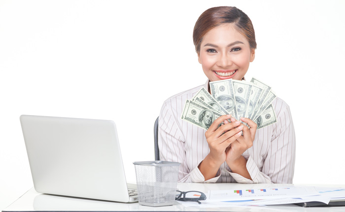 Young woman writer with laptop and a lot of money. Young woman writer with laptop and a lot of money.