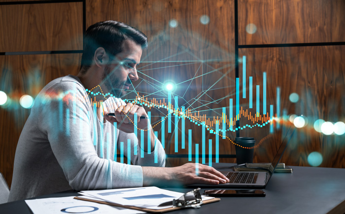 Young man studying crypto trading chart on his laptop. Young man studying crypto trading chart on his laptop.