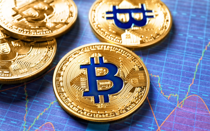 Gold BitCoins on blue background. Gold BitCoins on blue background.