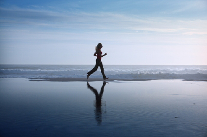 Create Your future with your future. Grounded woman running on beach. Create Your future with your future. Grounded woman running on beach.