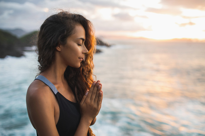 Woman young and beautiful. Hands pray on beach. Spiritual awakening. Woman young and beautiful. Hands pray on beach. Spiritual awakening.