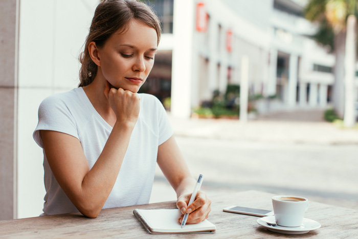 Young woman beginning to rewrite her life script. Young woman beginning to rewrite her life script.