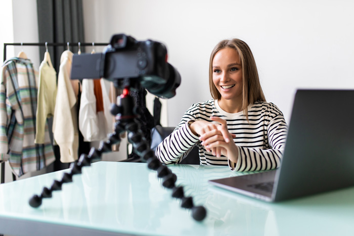 Young woman with video camera on tripod editing with InVideo. Women make money with InVideo Young woman with video camera on tripod editing with InVideo. Women make money with InVideo