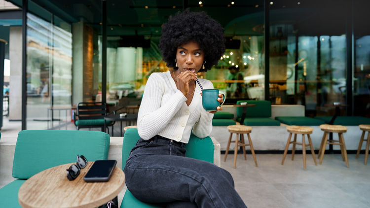 African-American woman in diner making a decision to change her life. African-American woman in diner making a decision to change her life.