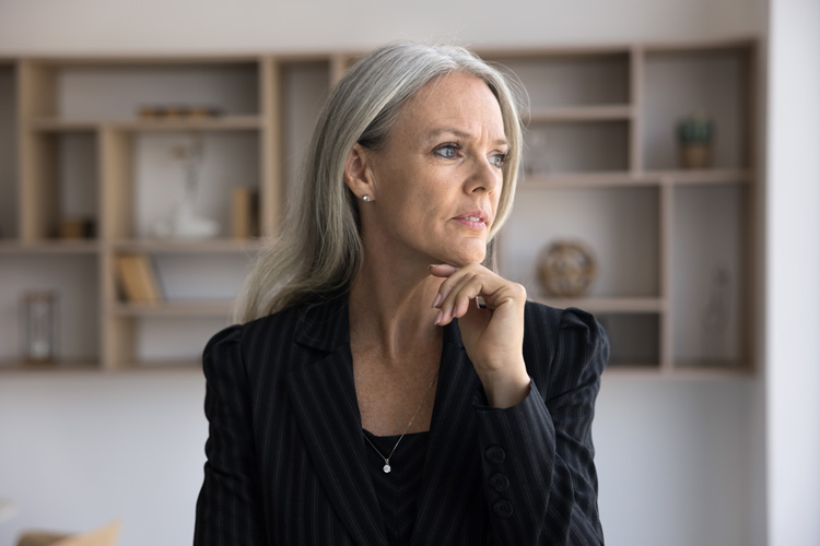 Beautiful mature woman in deep thought about the action she needs to take.