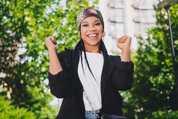 Young African-American woman cheering herself for taking positive action to change her life. Young African-American woman cheering herself for taking positive action to change her life.