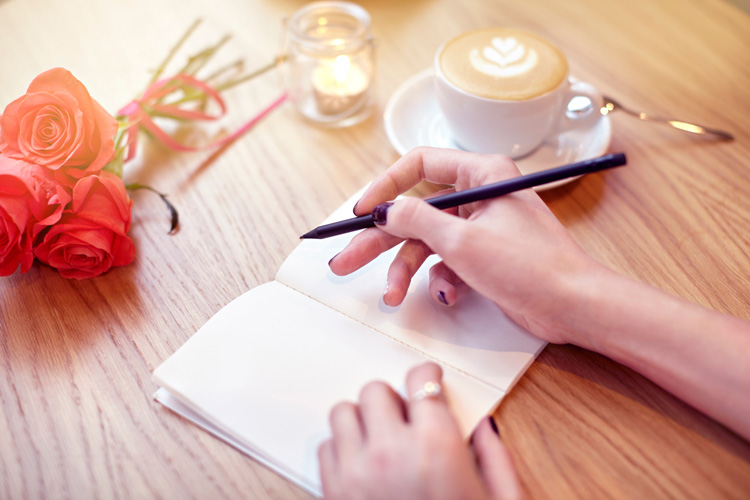 Woman writer's hands in her zen writing room.