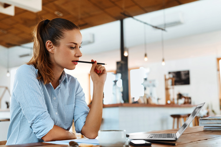 Young woman in coffee shop making good decisions that will positively change her life. Young woman in coffee shop making good decisions that will positively change her life.